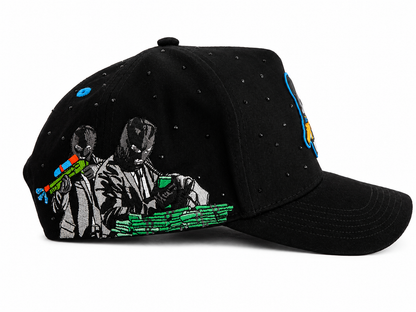 A black baseball cap embellished with rhinestones, featuring a graphic print of two characters in suits holding colorful toy guns, with green money getting put in the bag.