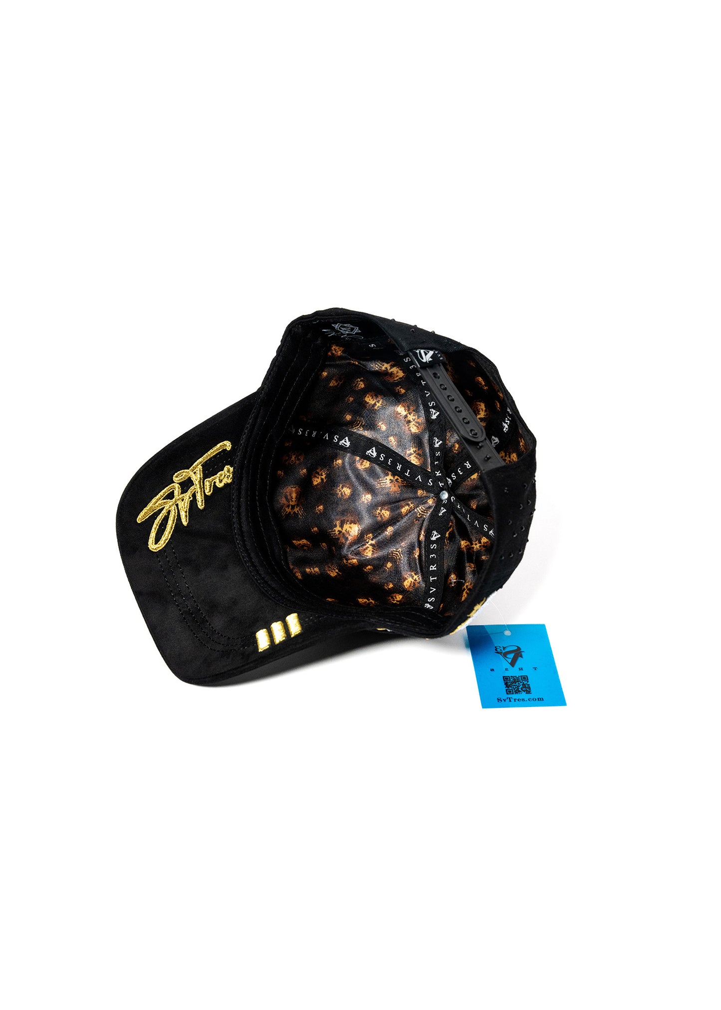 Black cap with gold svtres  text and punisher skull patterns on a satin fabric .